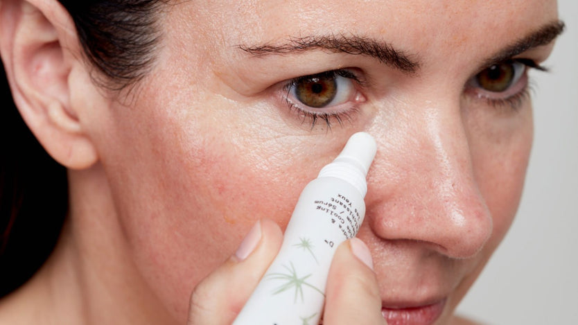 woman applying eye serum under her eye