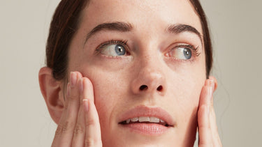 woman applying skincare to dry skin