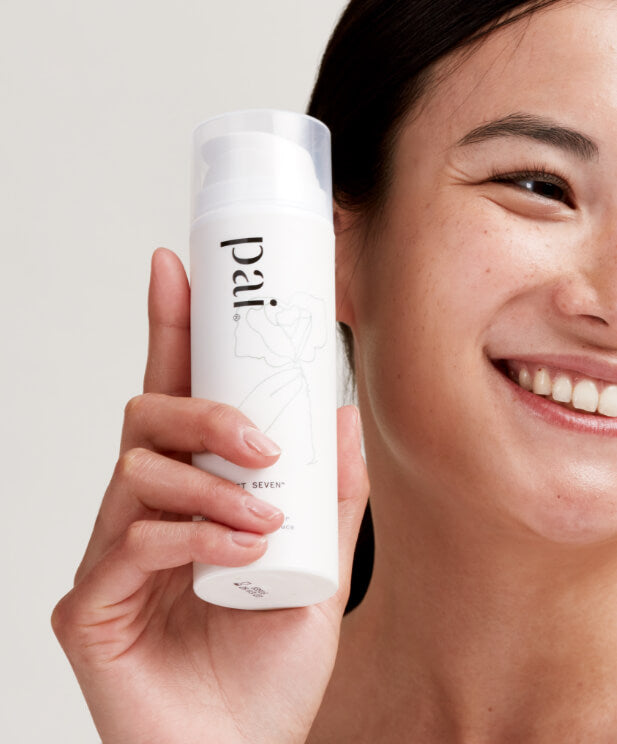 smiling woman holding cleanser