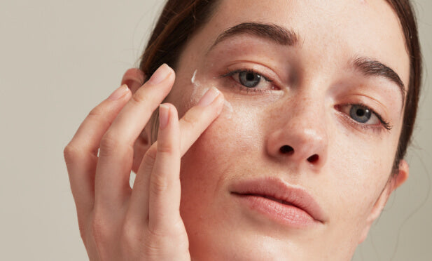 woman applying eye cream