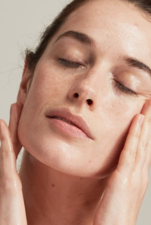 Woman applying face cream