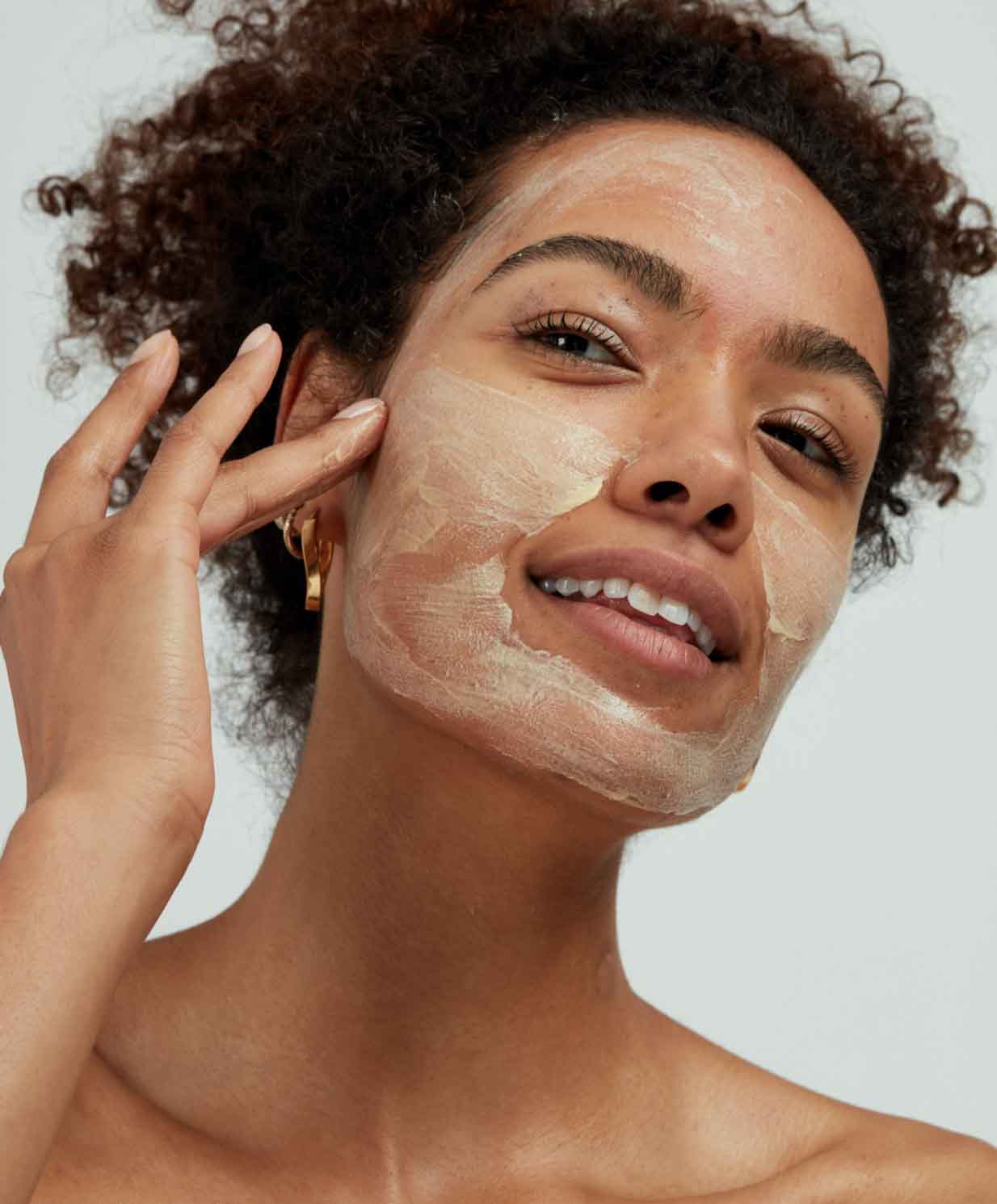 woman applying face mask to skin