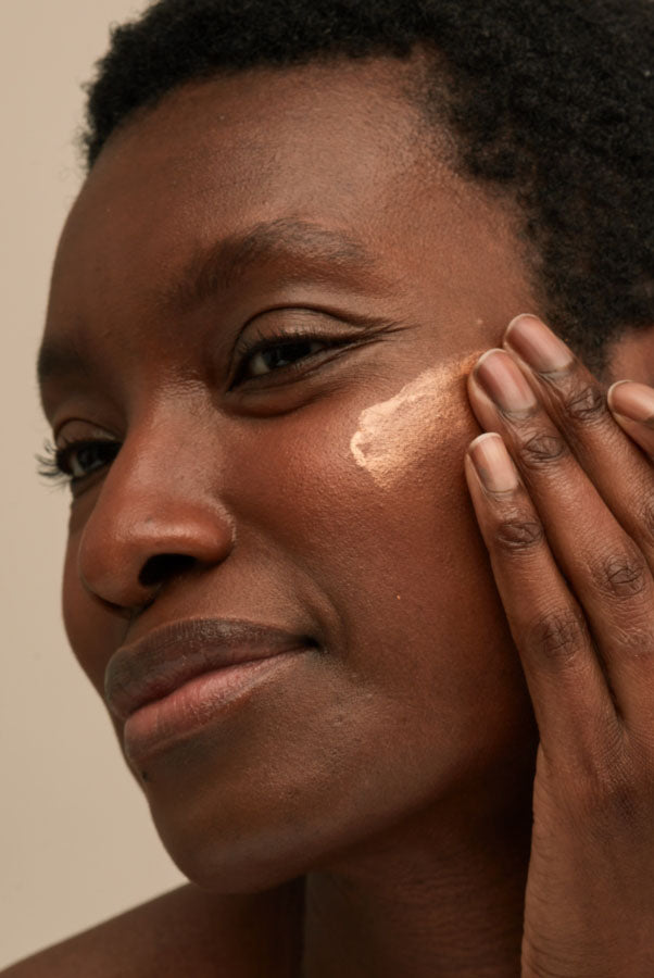 woman applying highlighter