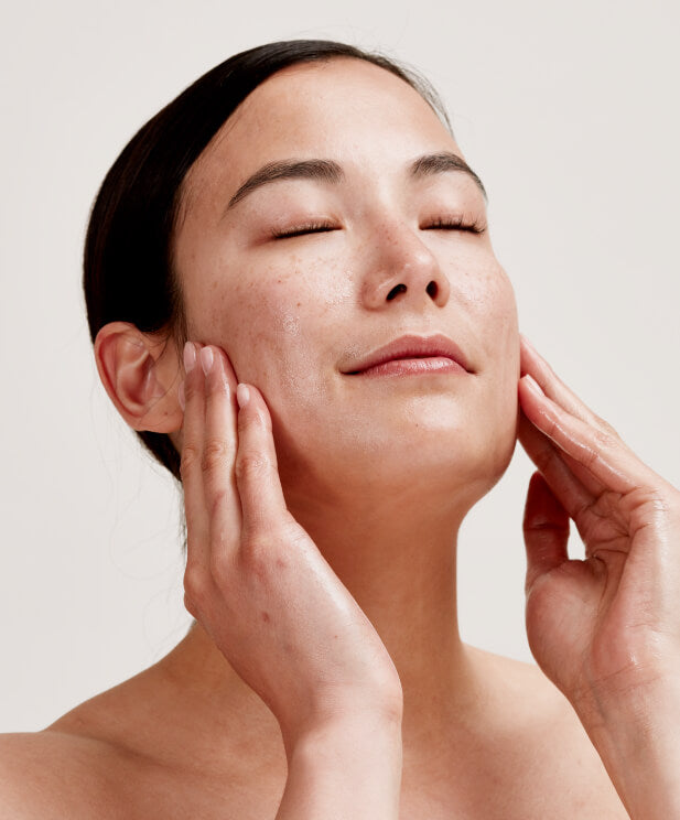 woman applying oil to skin