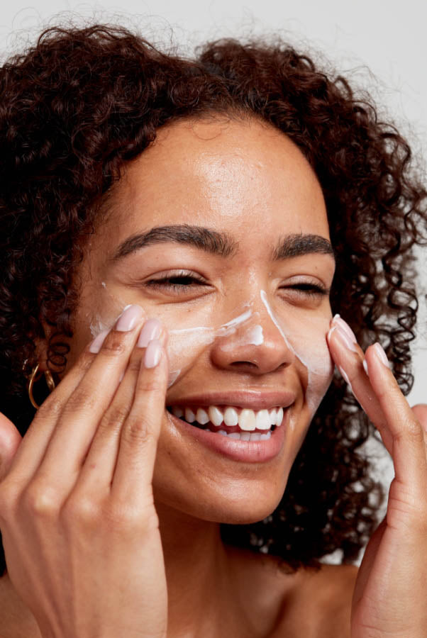 woman cleansing her skin