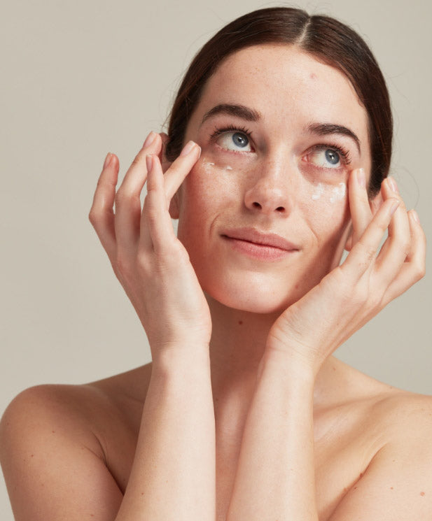 Woman applying eye cream