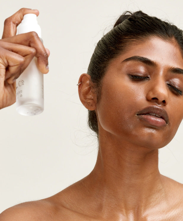 woman applying face mist