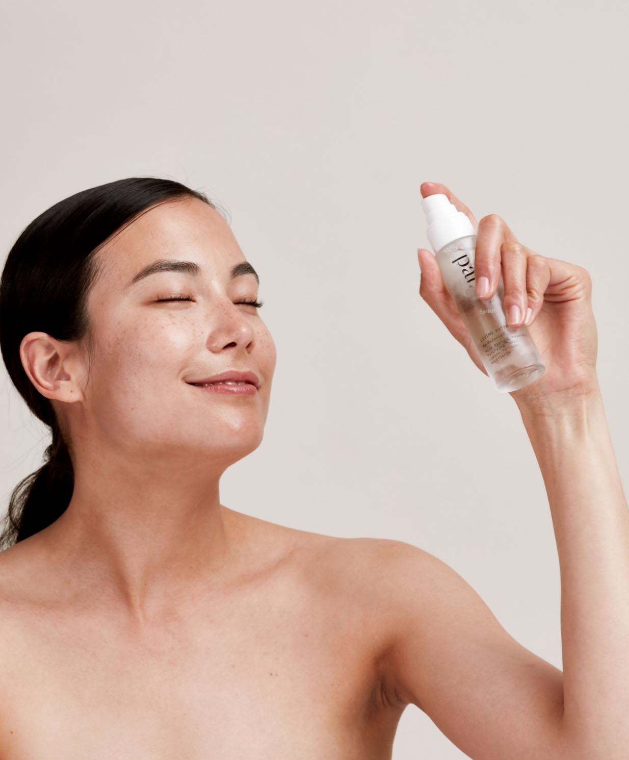 Woman applying face mist