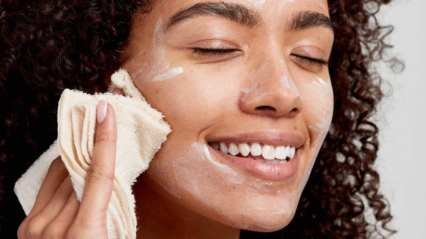 woman wiping off cleanser with muslin cloth